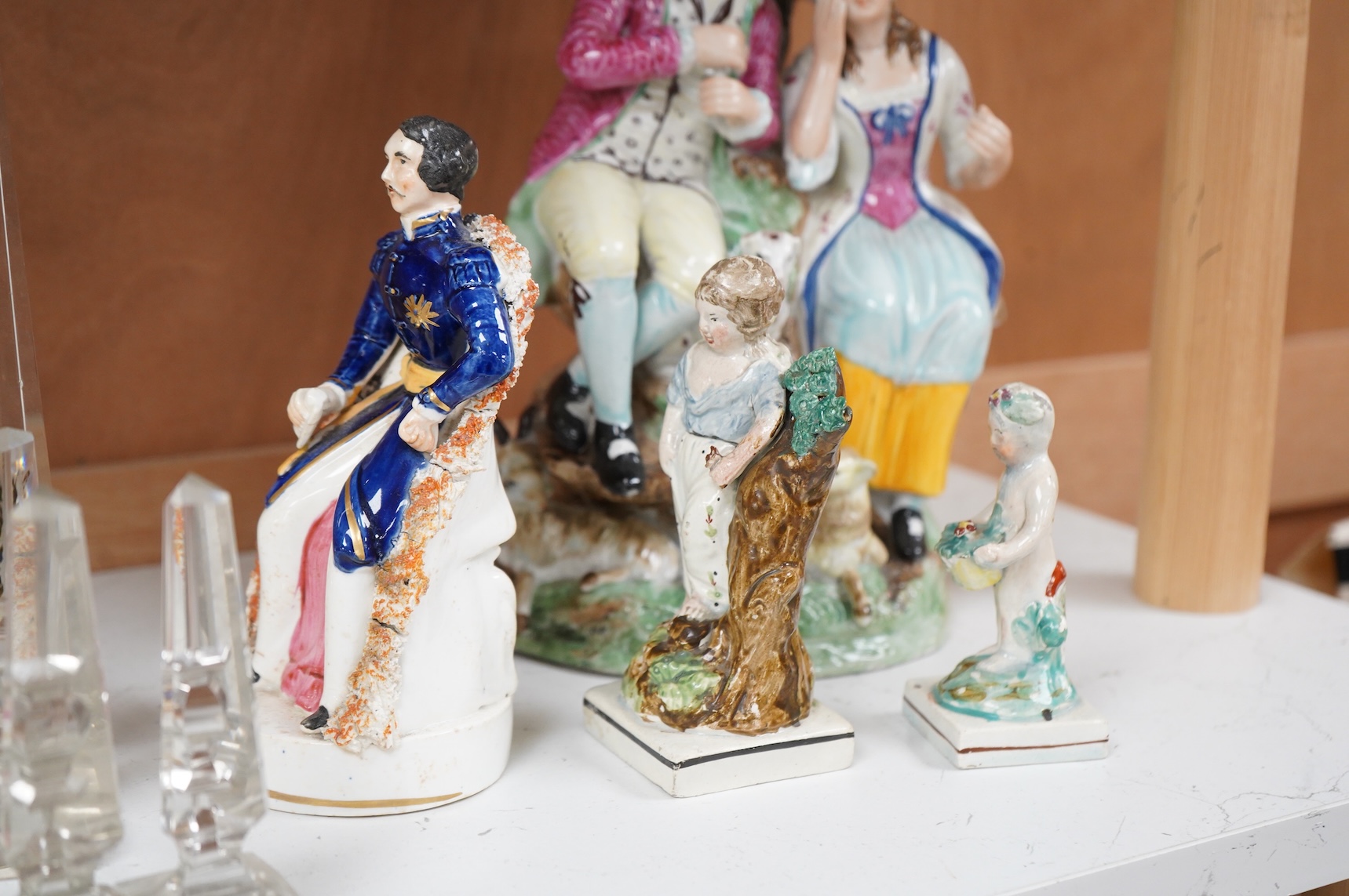 A Ralph Wood style group and three Staffordshire figures, largest 26cm high